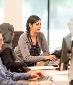 unknown persons using computer indoors