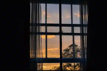 photo of blue framed glass window with curtain