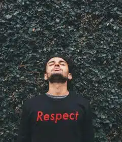 person standing behind green leafed plants